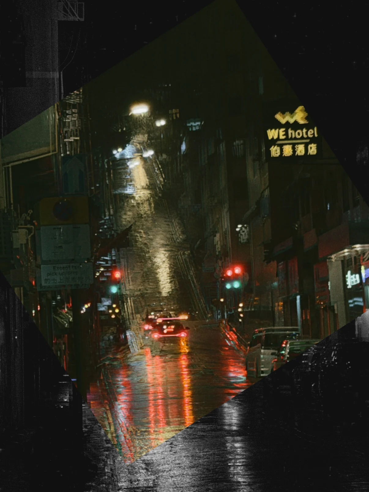A wet Hong Kong street at night with lights reflected on the road