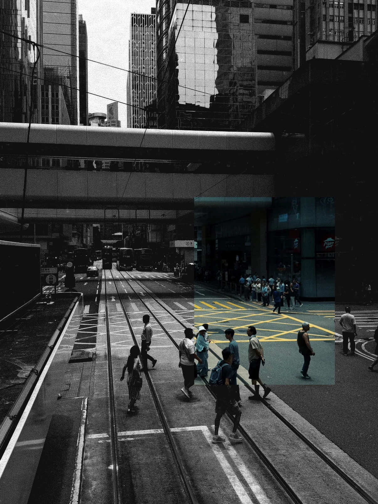 People crossing tram tracks between tall buildings in Hong Kong, in black and white with one strip left in colour